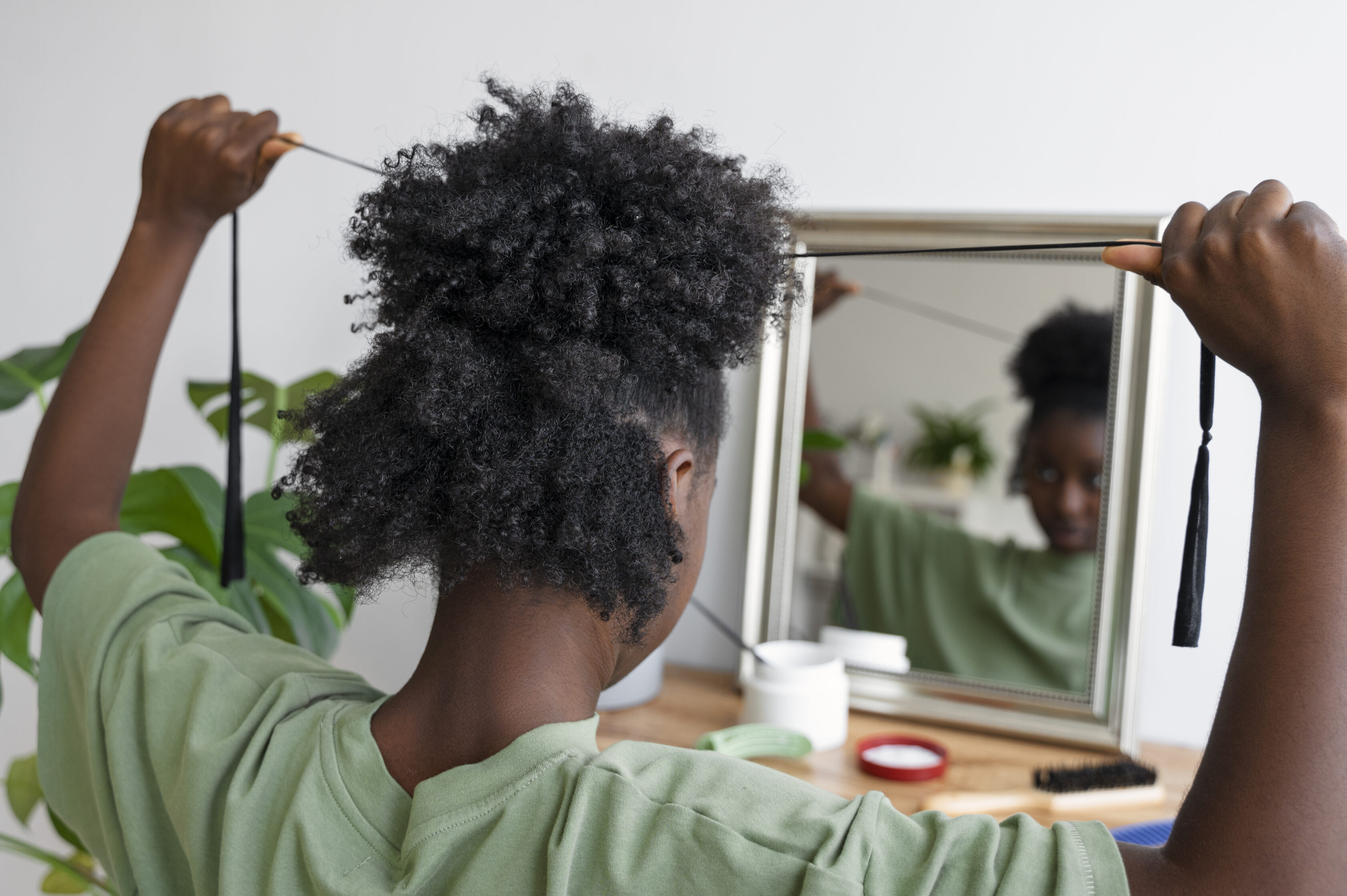 side-view-woman-arranging-hair-mirror